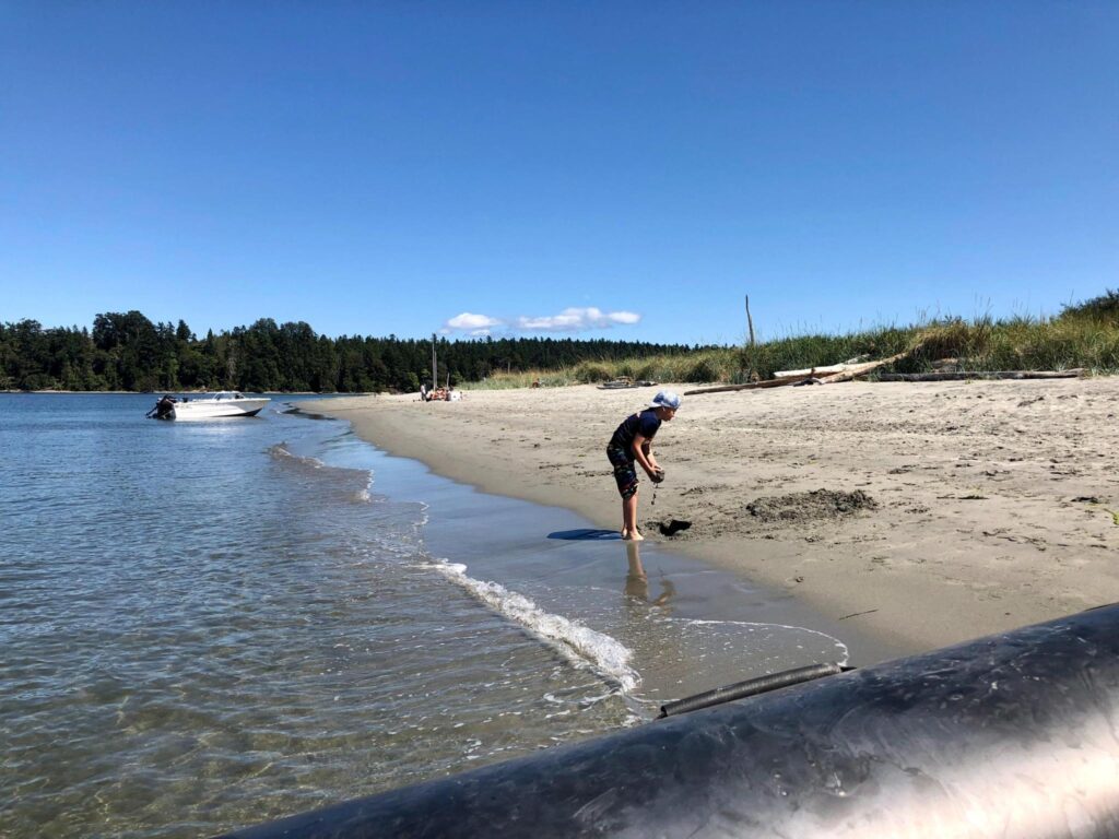 boy playing in sand on beach